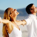 Young Stress Free Couple Enjoy The Summer Sun On The Beach