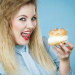 Woman Licking Lips As Shes About To Eat A Cream Cake