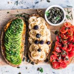 Healthy Foods On Toast On Top Of A Wood Chopping Board