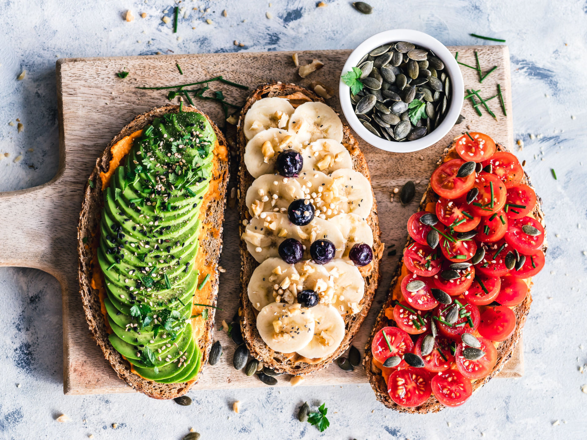 Healthy Foods On Toast On Top Of A Wood Chopping Board