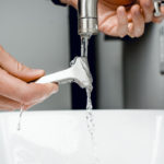 Close Up Of A Razor Being Washed Under The Tap