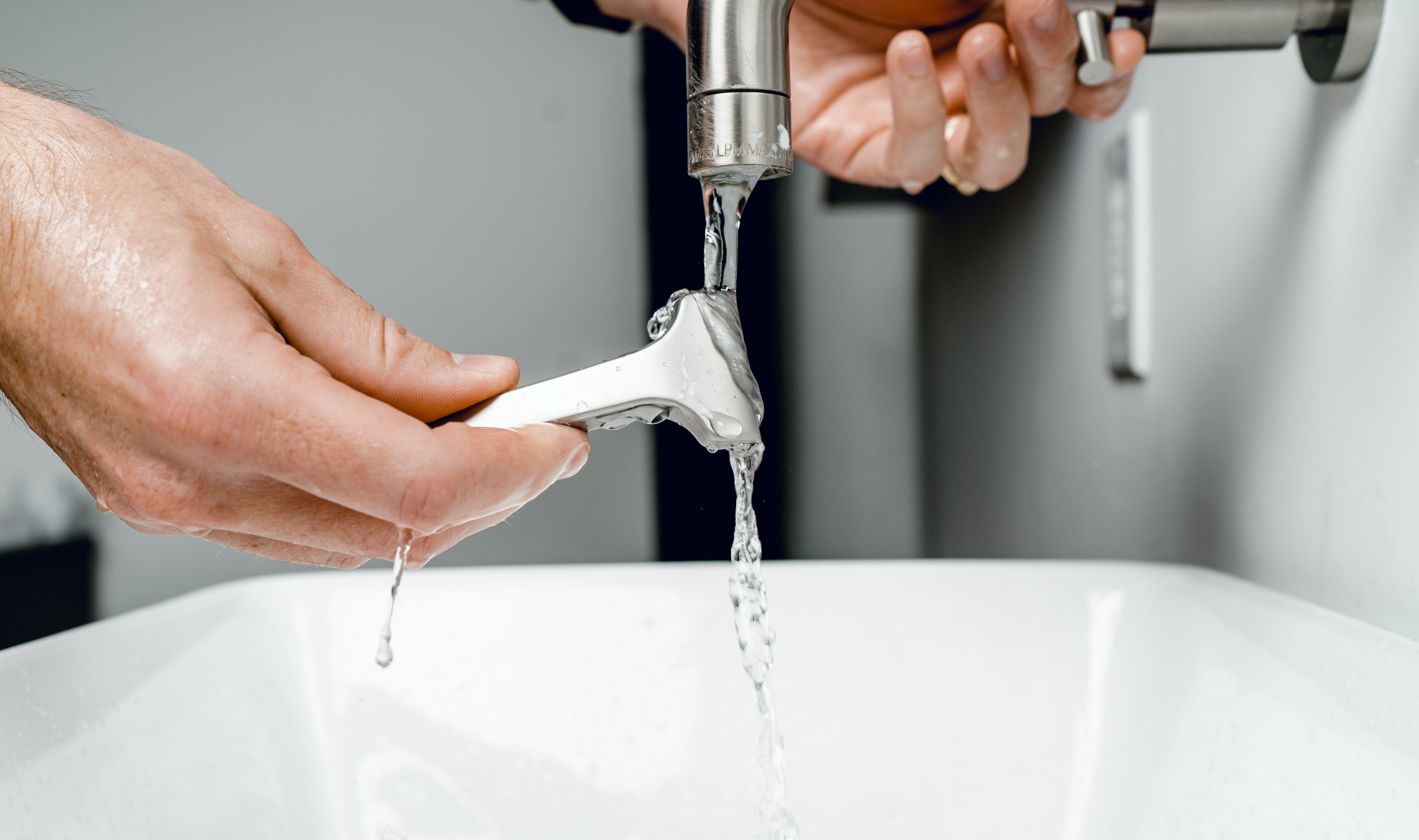 Close Up Of A Razor Being Washed Under The Tap