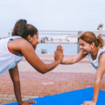 Two Woman Giving Each Other A High Five