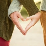 A Couple Making A Heart Shape While Holding Hands