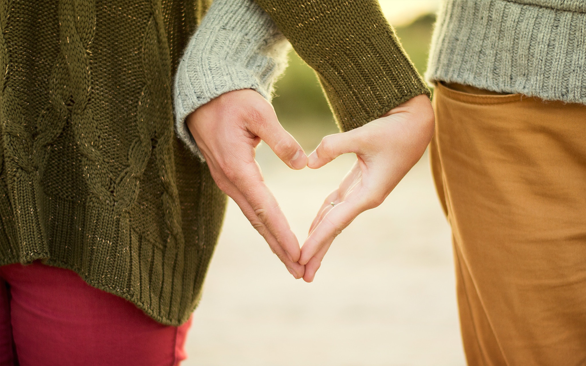 A Couple Making A Heart Shape While Holding Hands