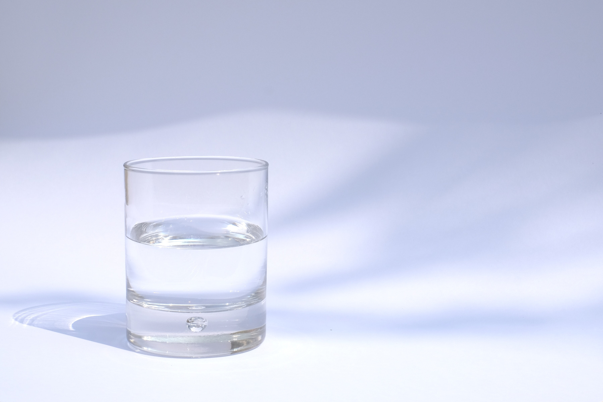 A Glass Of Water On A Light Background