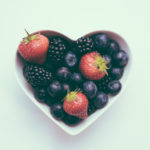Heart Shaped Bowl With Fruit On A White Background