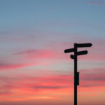 Silhouette Of Sign Post On Red Sky