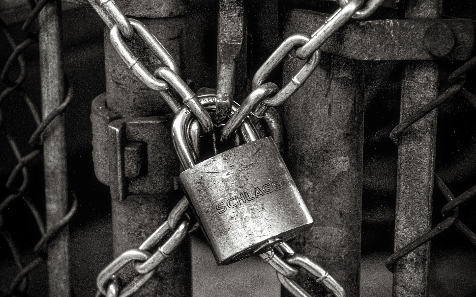 Iron Gate with a Steel Padlock Locking Chains Together